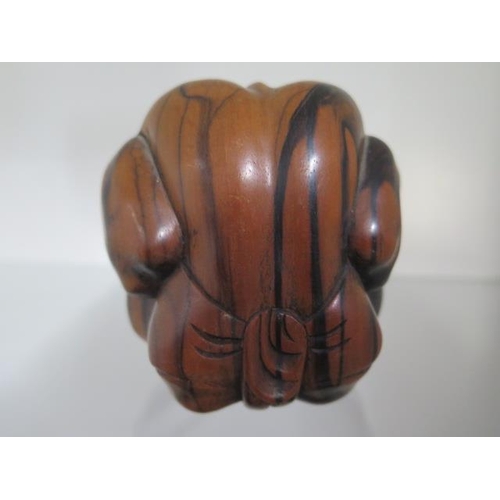 284 - A carved hardwood figure of a man rolled into a ball, 9cm tall, in good condition