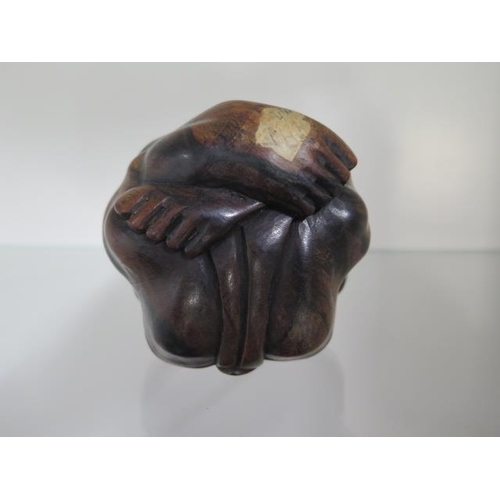 284 - A carved hardwood figure of a man rolled into a ball, 9cm tall, in good condition