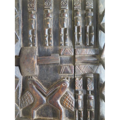 297 - A Dogan Mali carved granary door with figures and birds, overall 64cm x 42cm