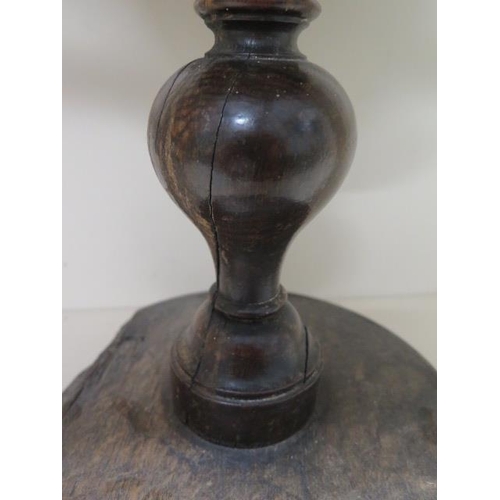 306 - A turned wooden antique bowl on stand, 37cm tall x 22cm diameter, in worn repaired condition with go... 