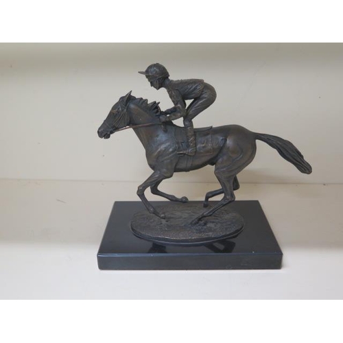 307 - A David Cornell bronze jockey and racehorse, dated 1985, 20cm tall, on a black marble base in good c... 