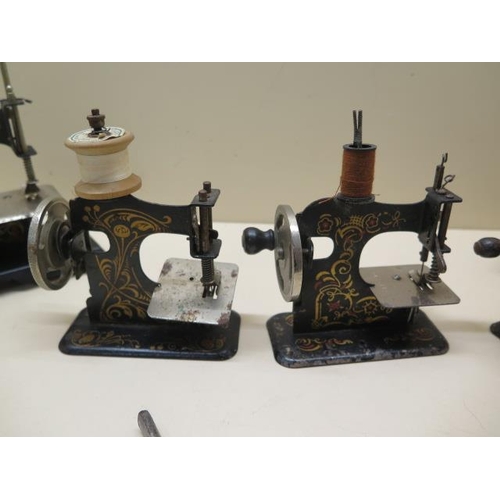 318 - Five vintage miniature hand crank sewing machines, from 13cm to 17cm tall