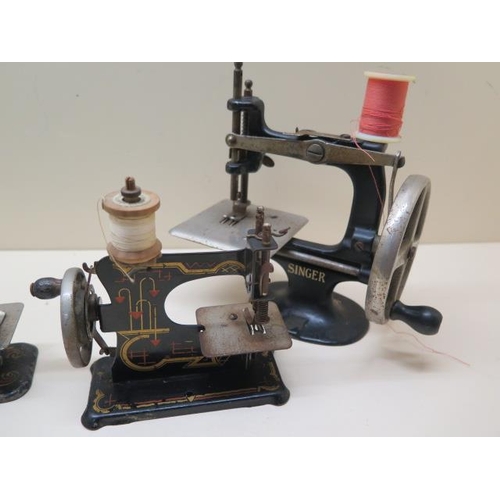 318 - Five vintage miniature hand crank sewing machines, from 13cm to 17cm tall