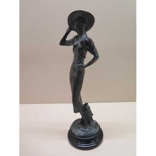 325 - A bronze figure of a 1920s girl on a black slate base