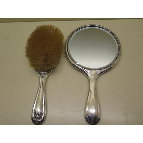 438 - A silver back mirror and hair brush