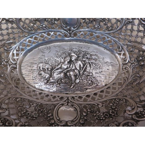 441 - A Continental white metal embossed bon bon dish 24cm wide, approx 6.6 troy oz and a pair of silver b... 