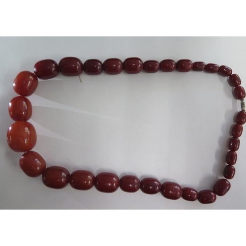 471 - An amber type necklace 67cm long, largest bead approx  3 cm x 2.5 cm, total weight approx 156 grams