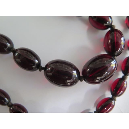 472 - A cherry amber similar type bead necklace, 104cm long, largest bead approx 2.5 cm x 1.5 cm, approx 8... 