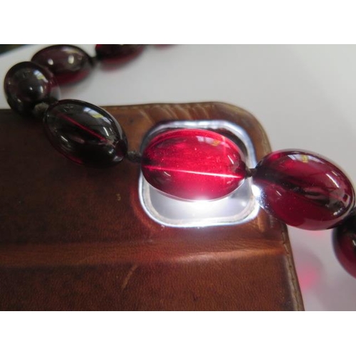 472 - A cherry amber similar type bead necklace, 104cm long, largest bead approx 2.5 cm x 1.5 cm, approx 8... 