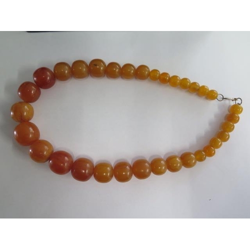 473 - A butterscotch similar type bead necklace, 52cm long, largest bead approx 2cm x 2.5cm, approx 118 gr... 