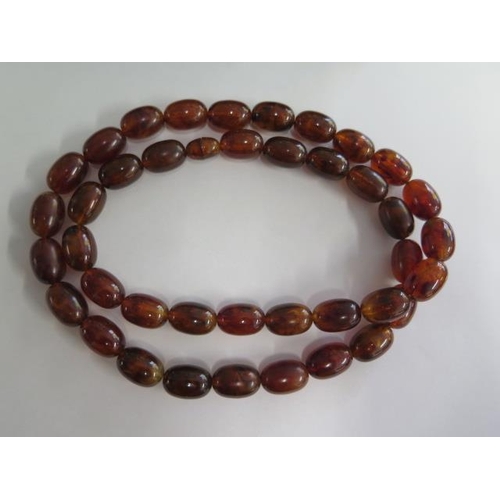 474 - An amber style beaded necklace, 80cm long, largest bead 2cm x 1cm, approx 96 grams