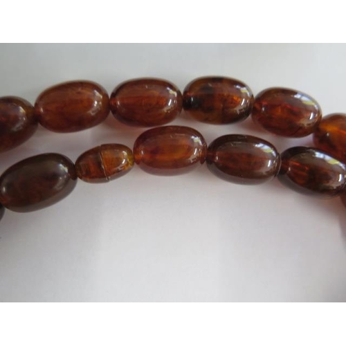 474 - An amber style beaded necklace, 80cm long, largest bead 2cm x 1cm, approx 96 grams