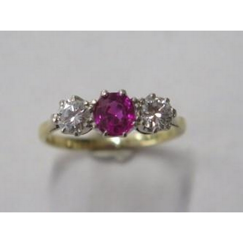 484 - An 18ct gold and platinum three stone diamond and ruby / spinnel ring, diamonds approx 0.20ct each, ... 