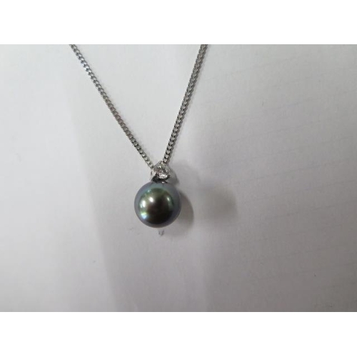 502 - A diamond and black pearl pendant on an 18ct white gold 42cm necklace, pearl approx 10mm, diamond ap... 