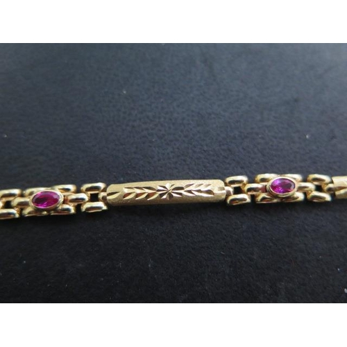 505 - An 18ct 750 yellow gold bracelet set with three rubies / spinnels, 18cm long, approx 7.2 grams