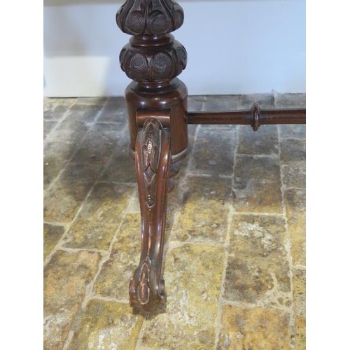 57 - A Victorian burr walnut stretcher table with a shaped top on carved supports united by a stretcher, ... 