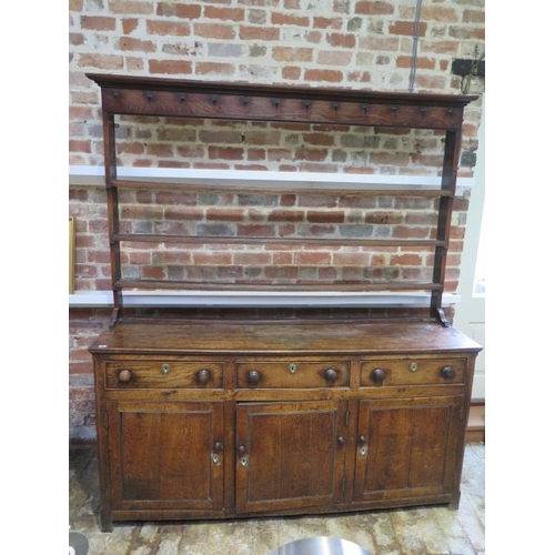 60 - A Georgian oak country dresser with an open rack top above 3 freize drawers and 3 cupboard doors, th... 