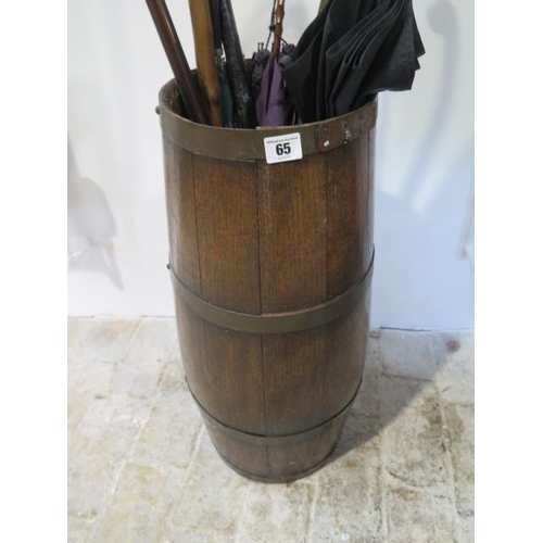 65 - An oak barrel stick stand with contents sticks, parasols, 60cm tall