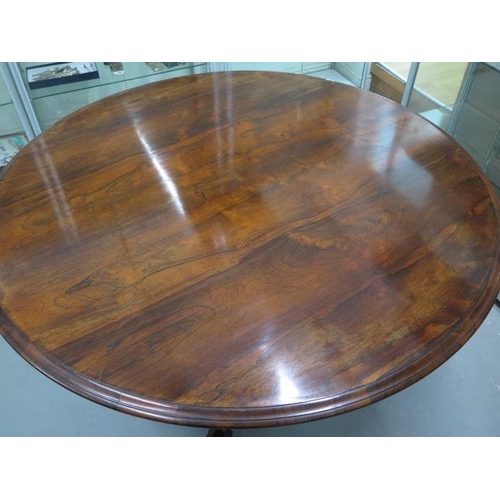 69 - A 19th century rosewood tilt top breakfast table of circular form on central bulbous stem and three ... 
