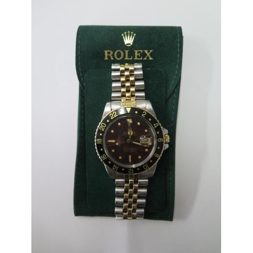 A 1980 bi metal Rolex Oyster Perpetual GMT-Master superlative chronometer gents bracelet wristwatch with Tropical nipple bronze brown dial black bezel and mercedes hour hand and 24 hour indicator, 40mm bezel, model 16753, serial 6274952, no box or papers, with service pouch, running, hands and date advance and adjust button winds in, some usage marks but generally good, 5 notches of adjustment left