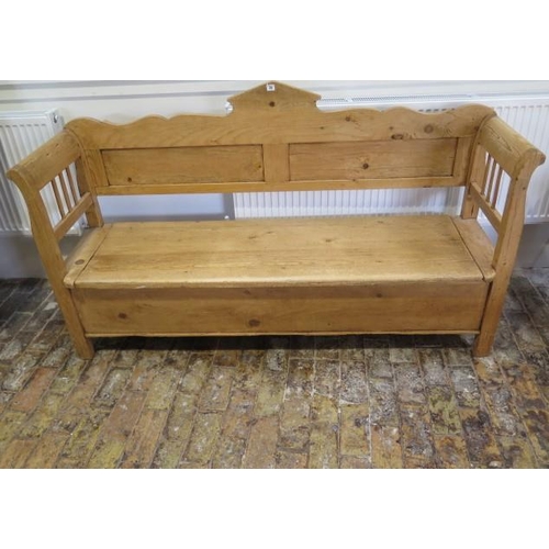 75 - A Continental stripped pine hall bench with a lift up seat with storage, 106cm tall x 183cm x 48cm