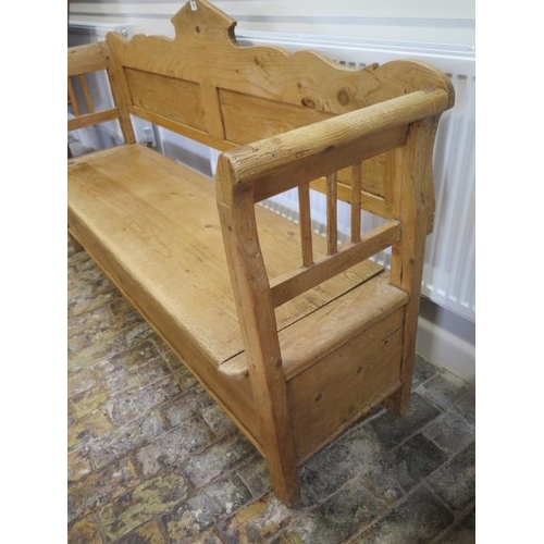 75 - A Continental stripped pine hall bench with a lift up seat with storage, 106cm tall x 183cm x 48cm