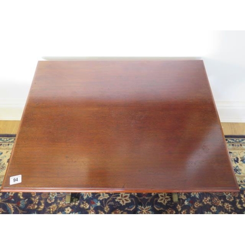 94 - A mahogany side table in the Regency style on twin supports with brass caps and casters, 46cm tall x... 