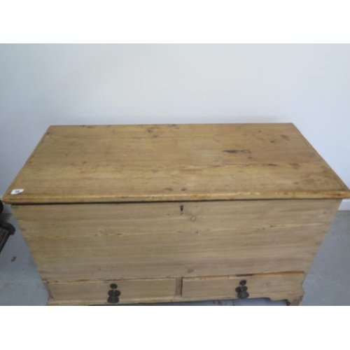 53 - A Georgian stripped pine two drawer mule chest with an interesting papered interior and secret drawe... 