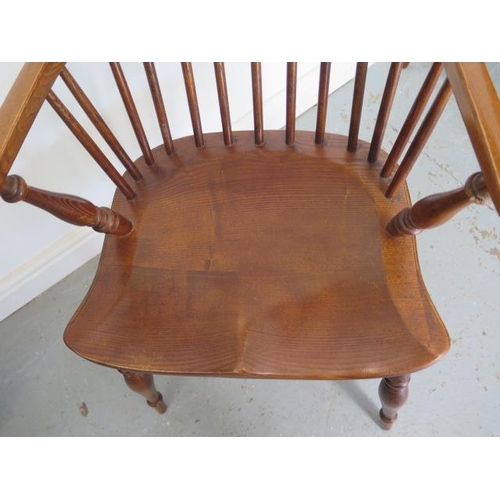 10 - An ash and elm 19th century style Windsor stick back elbow chair with a crinolene stretcher, 92cm ta... 