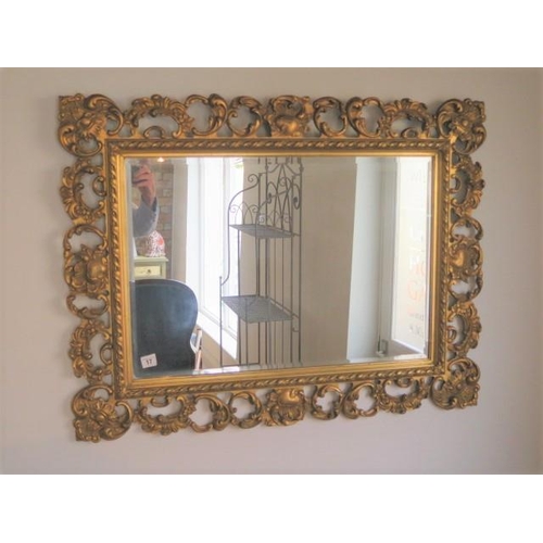 17 - An ornate gilt mirror, 72cm x 93cm
