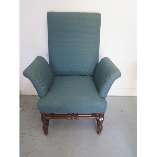 55 - A mahogany upholstered armchair on turned supports and stretchers, has been recovered at some stage,... 