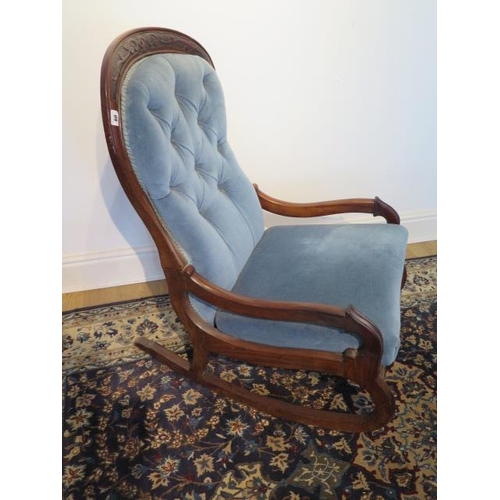 60 - A Victorian mahogany button back rocking chair, 98cm tall