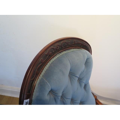 60 - A Victorian mahogany button back rocking chair, 98cm tall