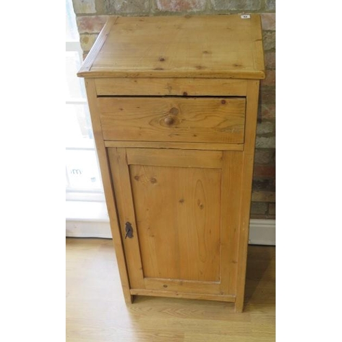 62 - A stripped pine clerks desk / podium with a slope above a drawer and cupboard, 120cm tall x 57cm x 4... 