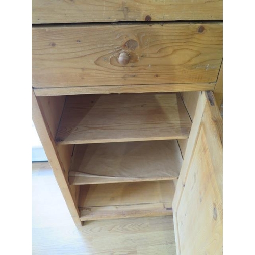 62 - A stripped pine clerks desk / podium with a slope above a drawer and cupboard, 120cm tall x 57cm x 4... 