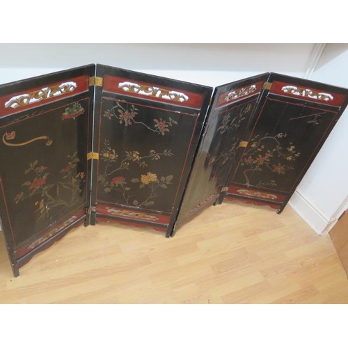 63 - An Oriental 4 fold lacquered vanity screen / divider, 105cm tall x 204cm wide
