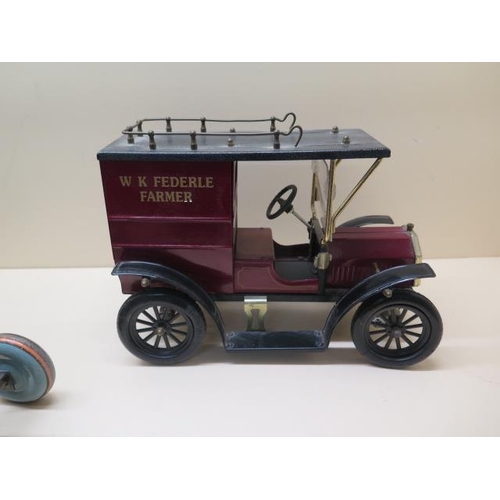 757 - A tinplate clockwork tractor, 22cm long, and two tinplate static