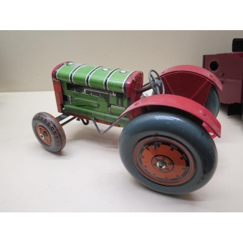 757 - A tinplate clockwork tractor, 22cm long, and two tinplate static