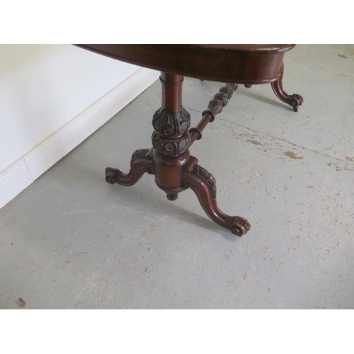 79 - A good Victorian burr walnut stretcher table with a shaped top on twin carved supports united by a c... 
