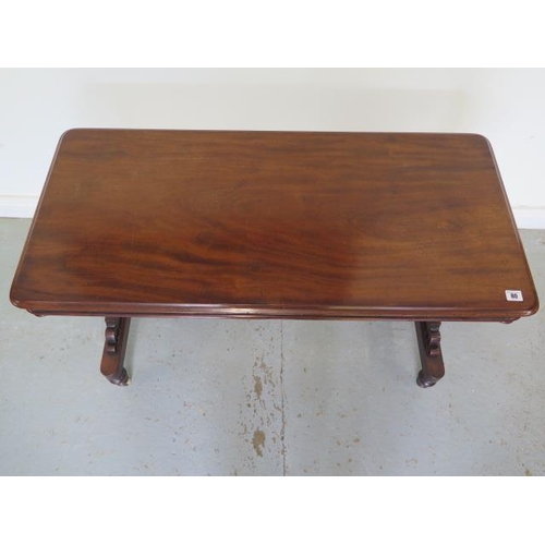 80 - A Victorian mahogany stretcher table with shaped twin pedestal supports united by a turned stretcher... 