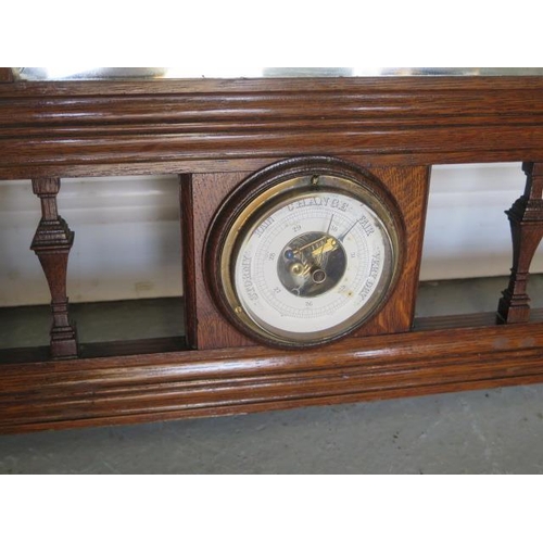 81 - An early 20th century oak framed wall mirror and coat / hat rack with small barometer, 94cm tall x 9... 