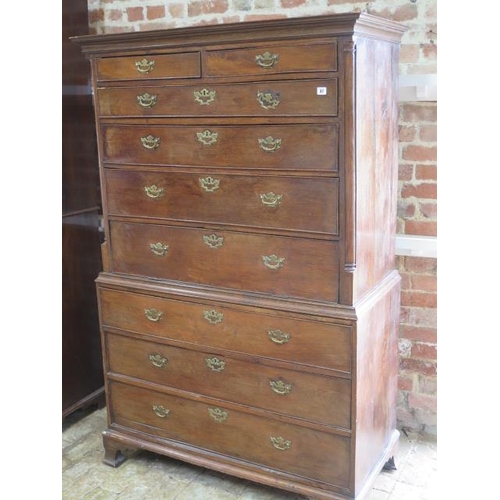 87 - A Georgian oak chest on chest with an adapted dropfront secretaire type writing section standing on ... 