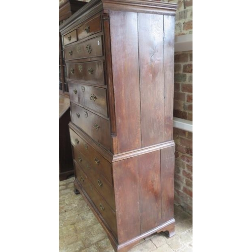 87 - A Georgian oak chest on chest with an adapted dropfront secretaire type writing section standing on ... 
