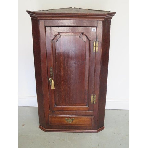 90 - A Georgian oak single door corner cupboard with a drawer and shaped shelves, 108cm tall x 67cm wide,... 