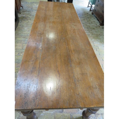 91 - A 19th Oak and Ash ? dining table with an end drawer on turned legs, 76cm tall x 260cm x 85cm