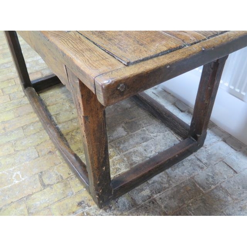 93 - An 18th century oak dining table with a 5cm thick top on square chamfered legs united by all round s... 