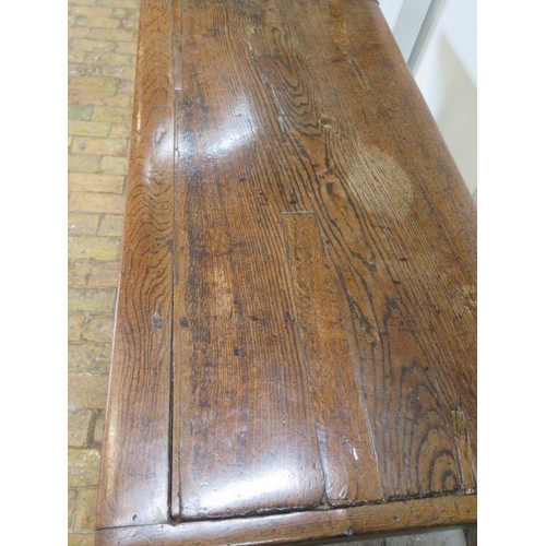 93 - An 18th century oak dining table with a 5cm thick top on square chamfered legs united by all round s... 