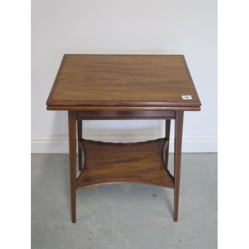 94 - An Edwardian Edwards and Roberts mahogany foldover top side table with an undertier, 66cm tall 51cm ... 