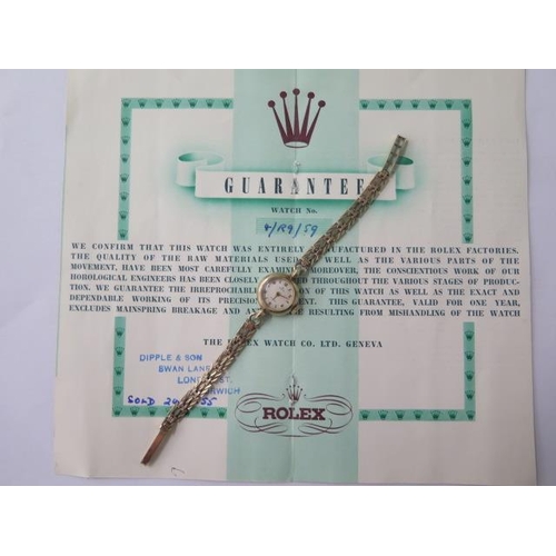 A 9ct yellow gold ladies 1955 Rolex manual wind bracelet wristwatch with original guarantee, 18mm case, 18cm strap, total weight approx 13.4 grams, hands adjust, working, good condition