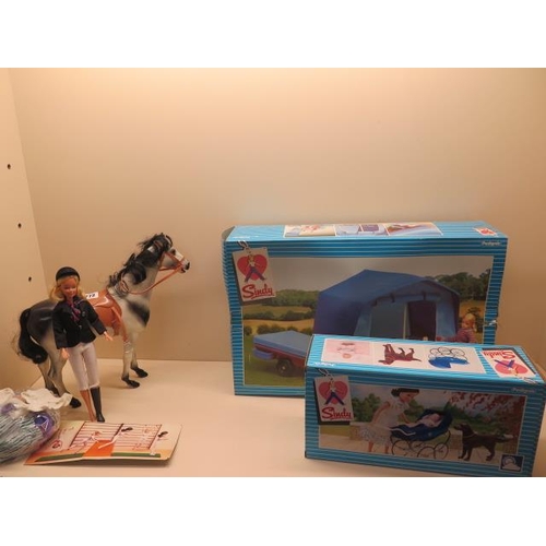 772 - A boxed Sindy Trailer Tent, a boxed Sindy Pram , a Sindy and Horse and assorted clothes